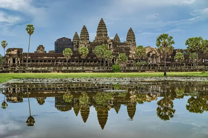 Angkor Wat and its towers mirrored in the pond in daylight on a two-day Angkor Wat and floating village tour