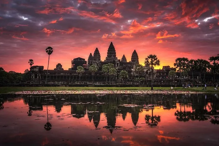 Angkor Wat reflected in the pond under a red sunrise sky on a private Angkor Wat, Ta Prohm and Angkor Thom tour