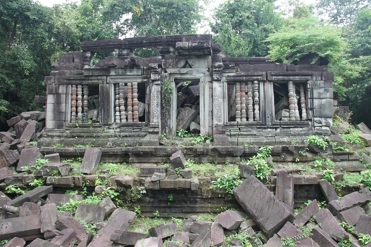 A gallery of Beng Mealea with collapsed blocks and trees growing through the ruin, seen on Angkor Wat tours from Siem Reap