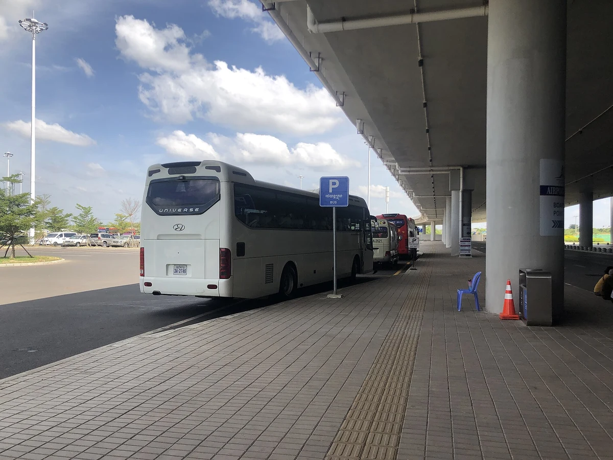 A coach parked under the terminal canopy at Siem Reap-Angkor International Airport, seen on Angkor Wat tours from Siem Reap