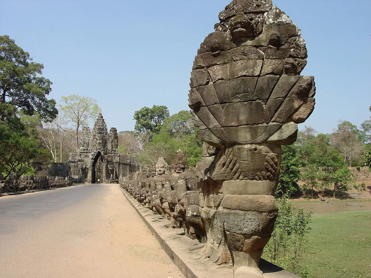The causeway to the South Gate of Angkor Thom lined with stone figures holding the naga, passed on Angkor Wat tours